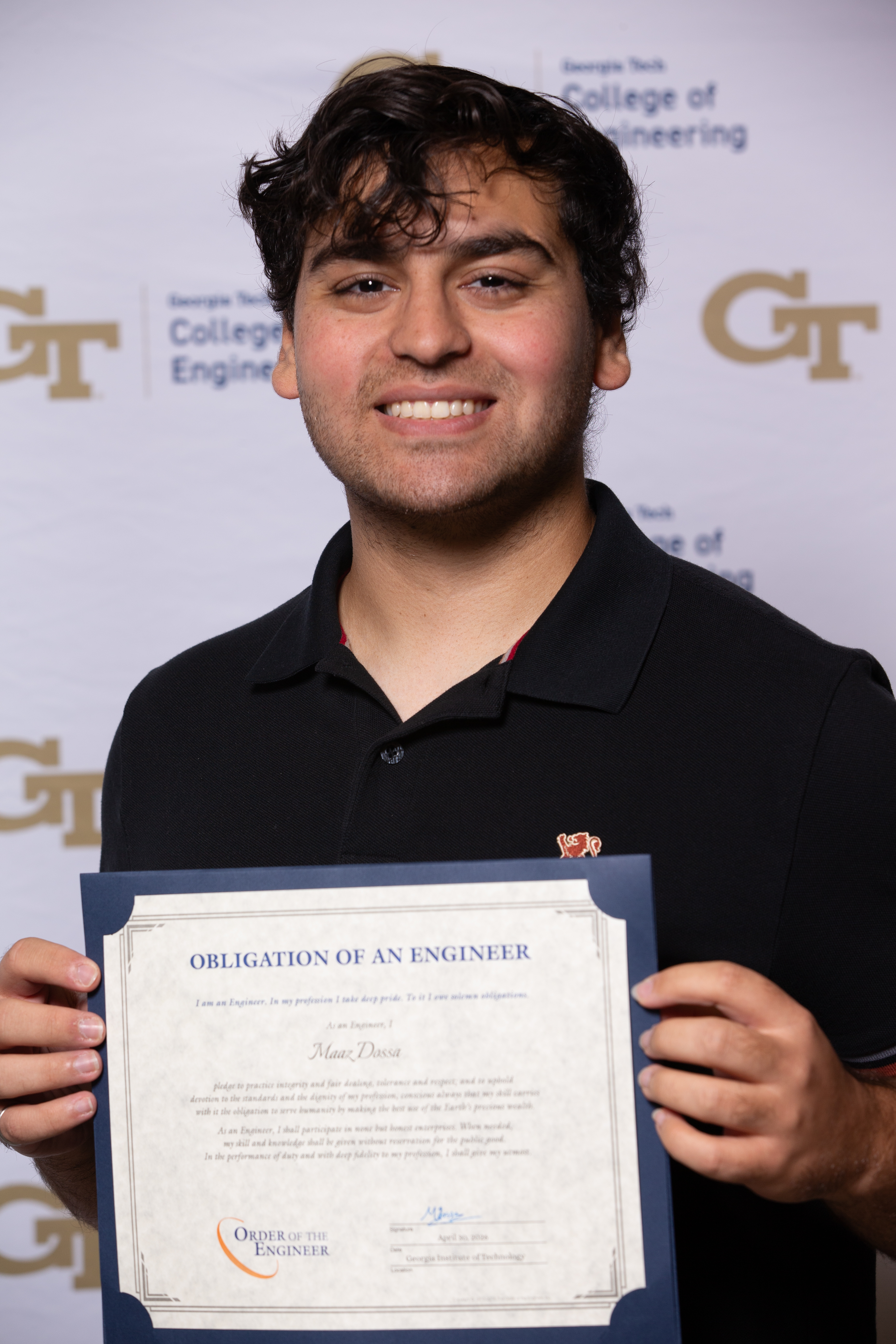 Maaz holding his Order of the Engineer certificate at Georgia Tech